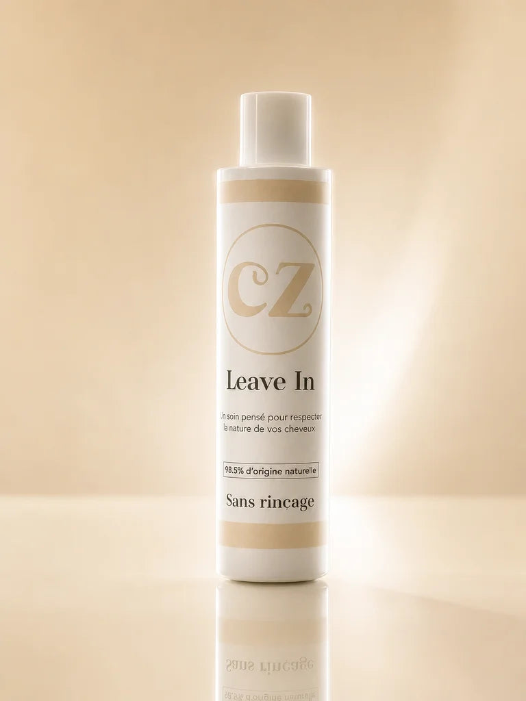 3:4 product photography. The Curlizz Leave-In flacon standing upright on a reflective cream surface,